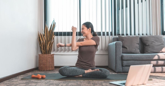 Woman exercising in her living room.